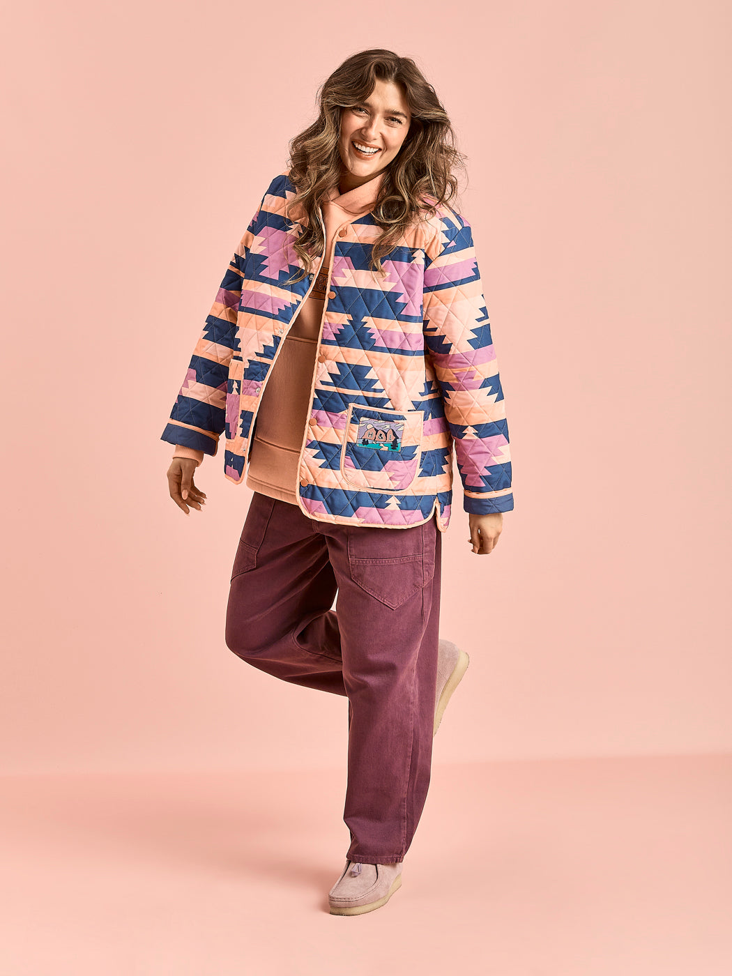 Female Model wears the Quilted button up jacket which features colours of Light Peach, Airforce, Deep Lavender & Lavender Mist.