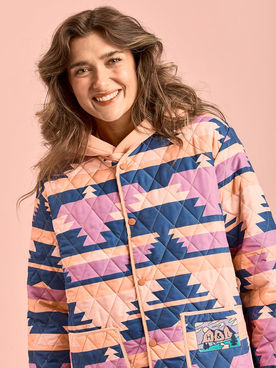 Female Model wears the Quilted jacket shown with the poppers done up.