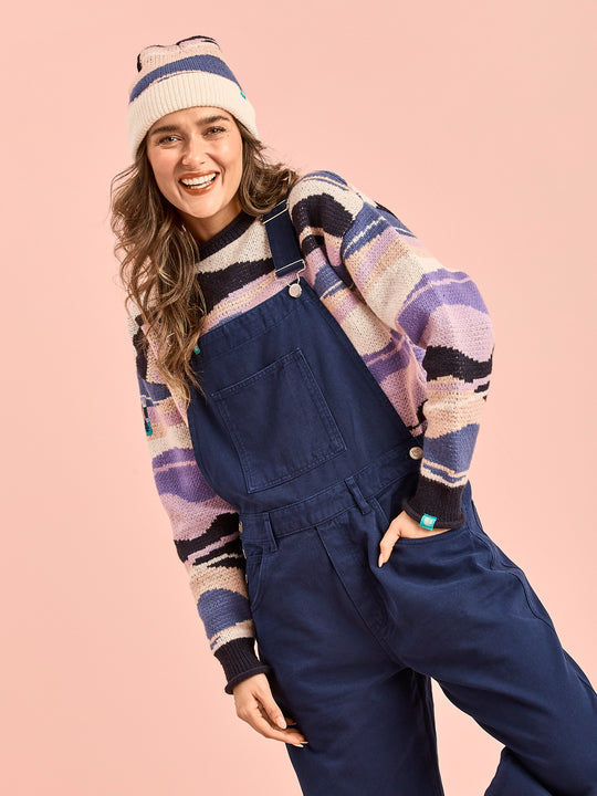 Female models wears the Aria true to size dungarees which features a bib pocket on the from panel