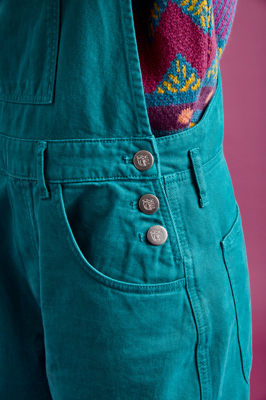 Detail shot of the three metal branded buttons for ease of taking off and getting on 