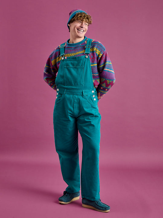 Full length shot of the male model wearing the dungarees, these feature a classic fit