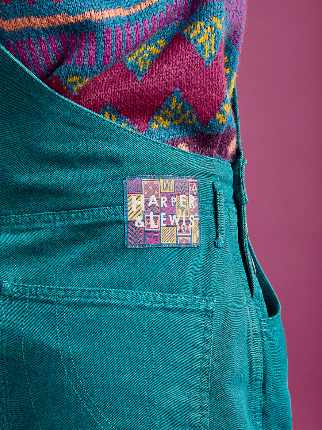 Detail shot of the branded aztec badge on the waistband of the new season dungarees