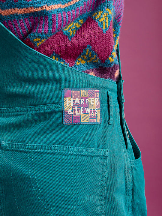 Detail shot of the branded aztec badge on the waistband of the new season dungarees