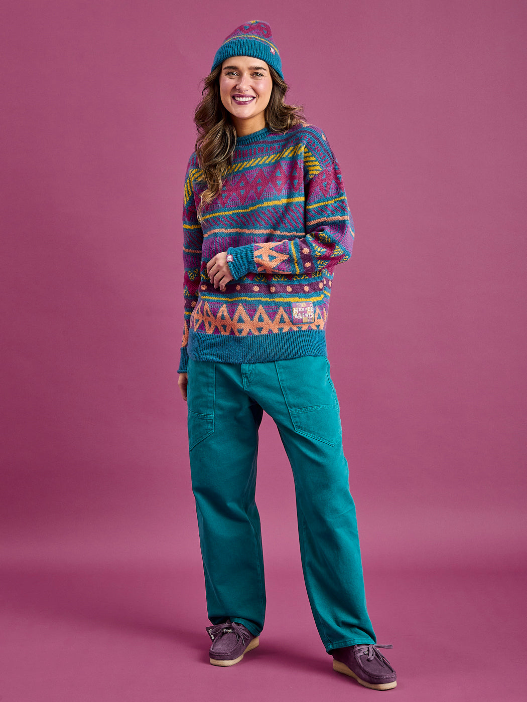 female model wearing the aztec wave patterned jumper with contrast ribbed cuffs, neckline, and hem in Teal.