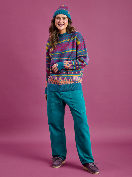 female model wearing the aztec wave patterned jumper with contrast ribbed cuffs, neckline, and hem in Teal.