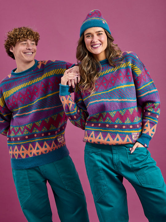 Both models wearing the unisex jumper crafted from 75% acrylic and 25% nylon, providing both warmth and durability.
