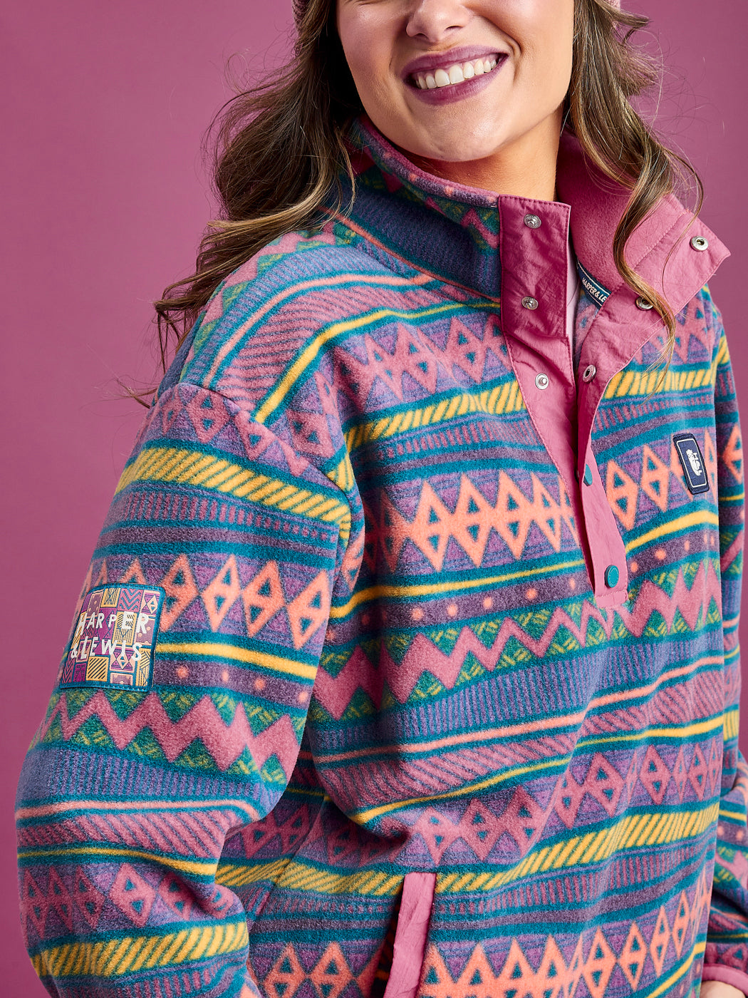 Detail shot of the Tallow fleece jacket, which features a branded woven badge on the arm