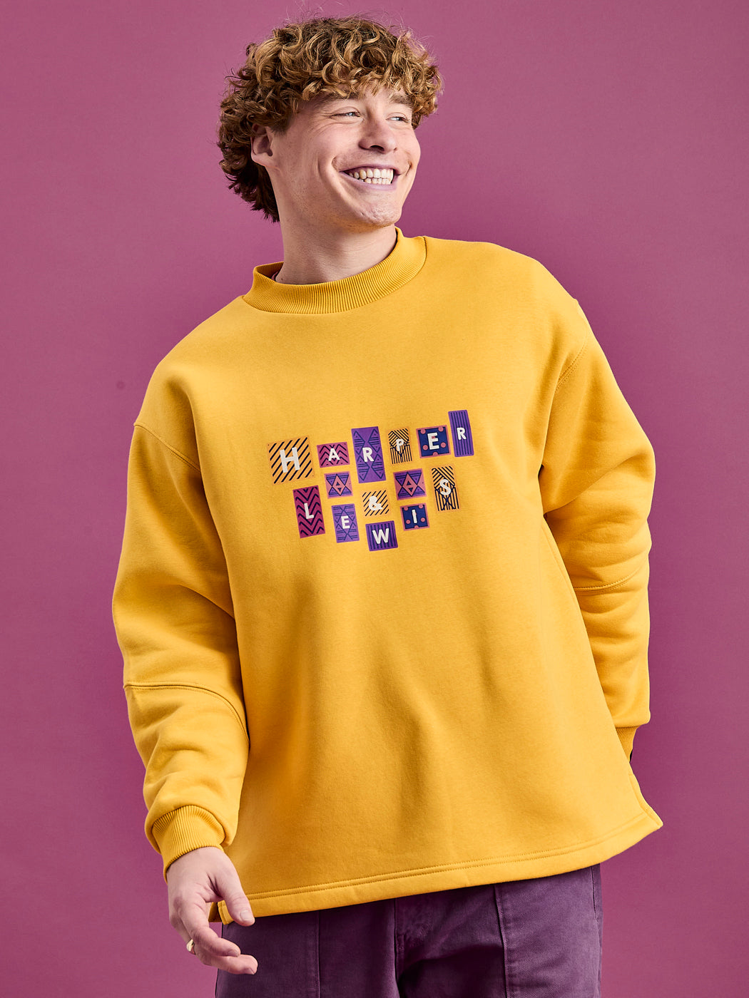 Male Model wears the oversized sweatshirt in a Mustard yellow colour.