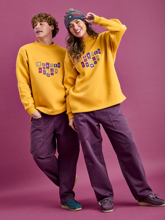 Both Models wearing the Mustard yellow unisex sweater, Crafted from a high-quality blend of 65% Cotton and 35% Polyester for softness and durability