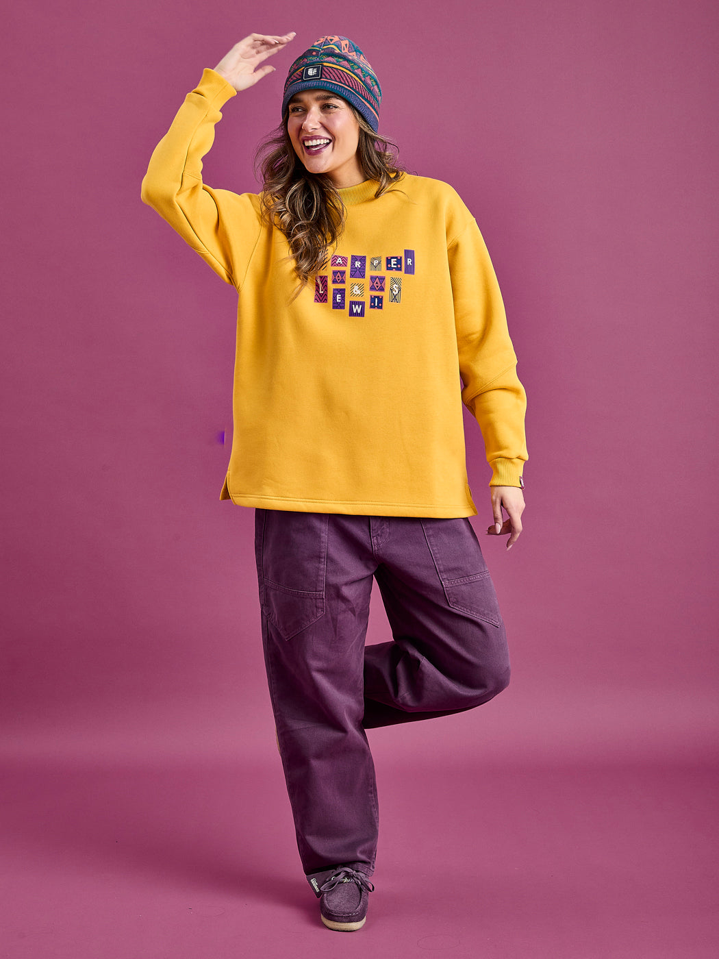 Female Model wearing the Oversized comfy sweater, styled with the Asani Trousers in Deep Mulberry.