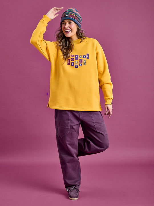 Female Model wearing the Oversized comfy sweater, styled with the Asani Trousers in Deep Mulberry.