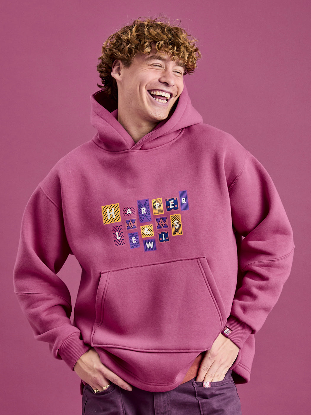 Male model wearing the oversized hoodie in Dark Rose.