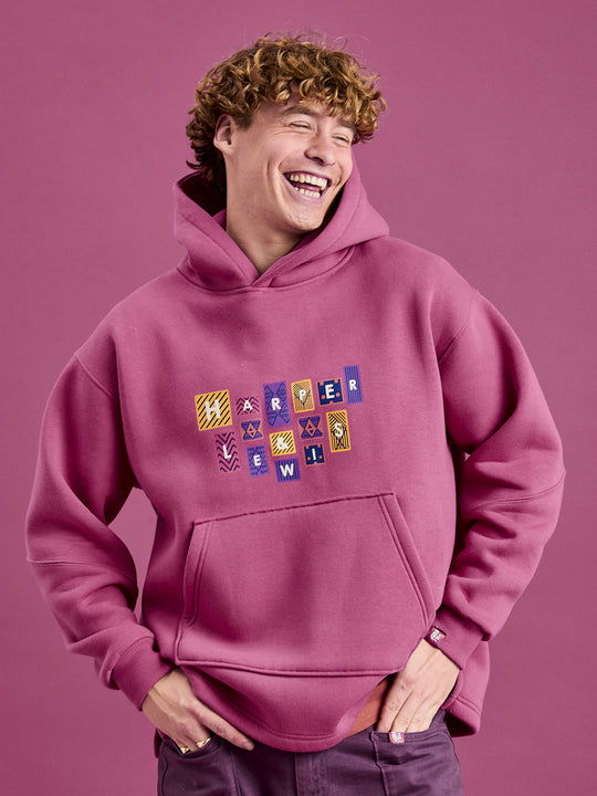 Male model wearing the oversized hoodie in Dark Rose.