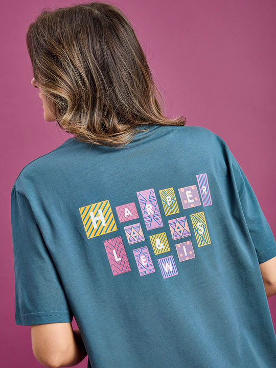 Female model wearing the Neva t-shirt with back Harper & Lewis Logo