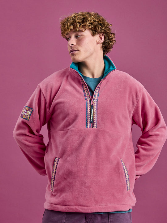 Male Model wearing the Bronwyn Fleece, featuring a Aztec patch on the left sleeve.