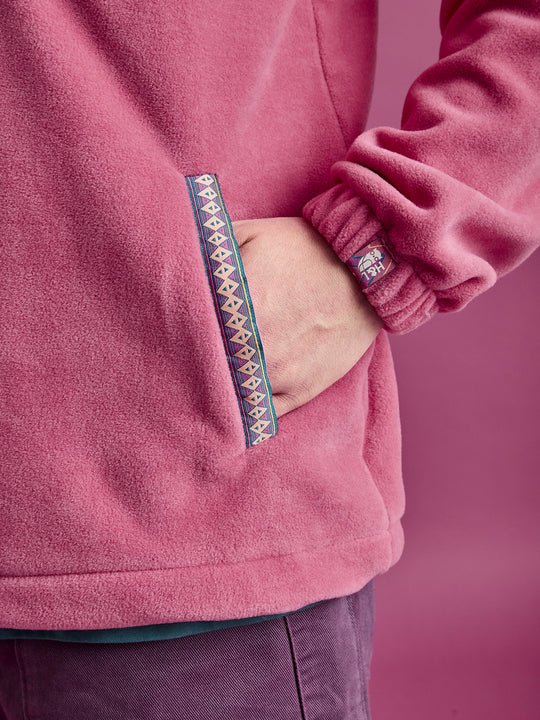 Close-up detail shot of the aztec tape on the pocket entry and the patch on the cuff.
