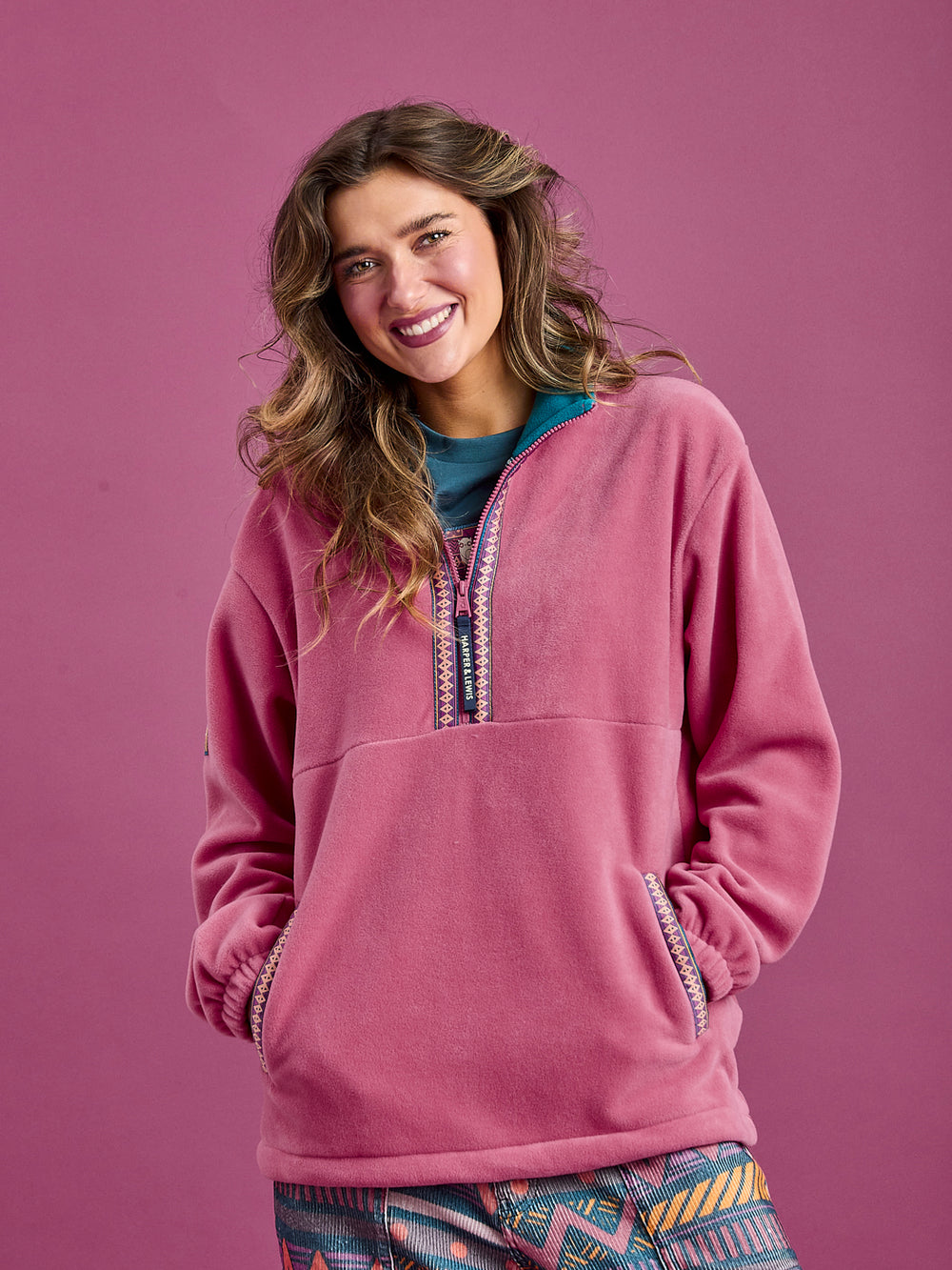 Female Model wearing The Bronwyn Fleece Jacket, showing the two side entry pockets.