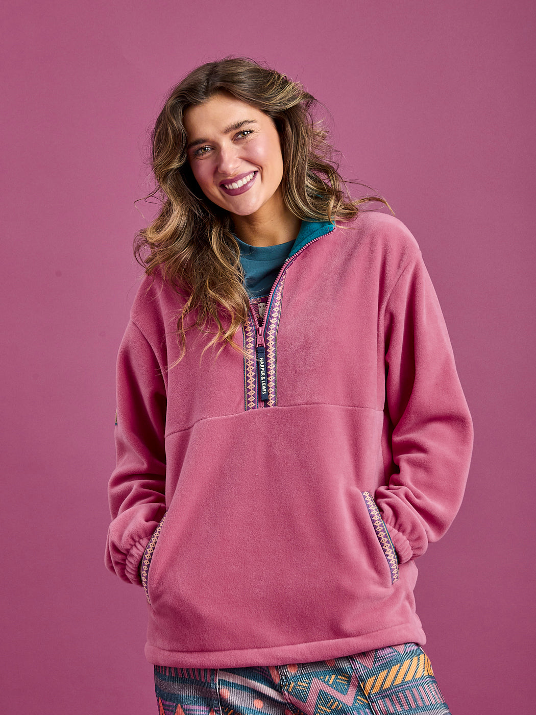 Female Model wearing The Bronwyn Fleece Jacket, showing the two side entry pockets.