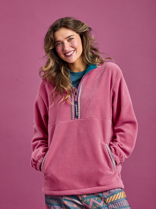 Female Model wearing The Bronwyn Fleece Jacket, showing the two side entry pockets.