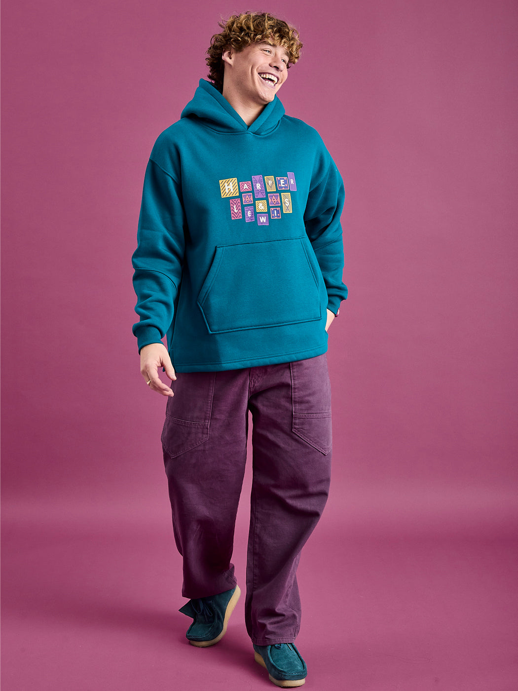 Male models wearing the oversized hoodie with the released hem.
