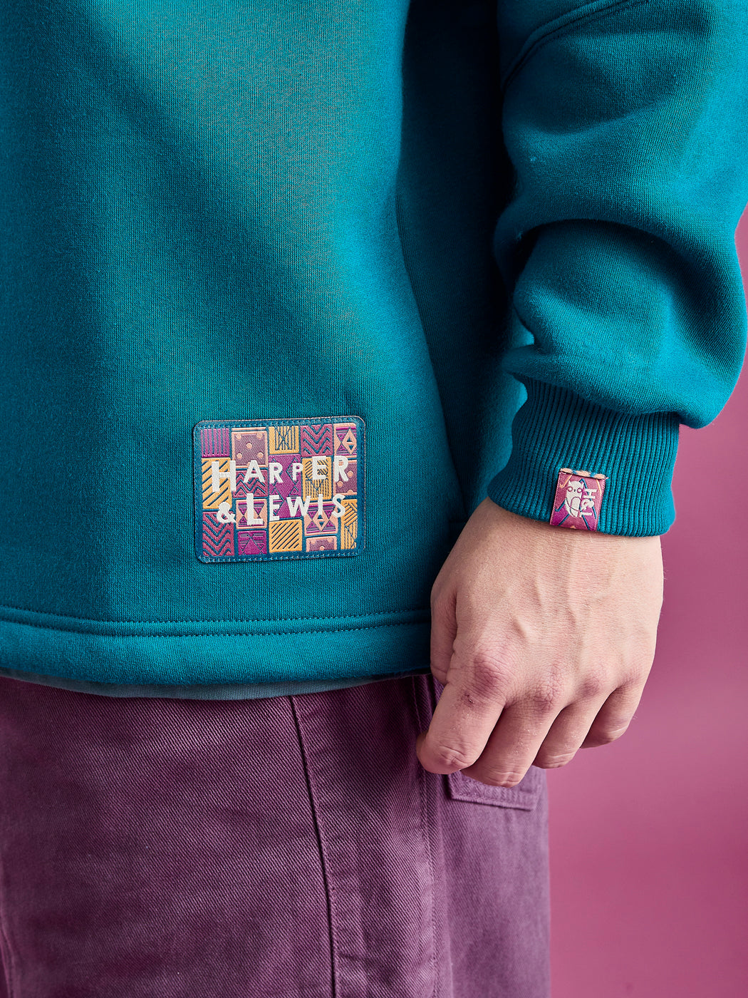 Detail shot of the aztec branded badge and cuff tab on the sleeve, this are both in the same pattern.