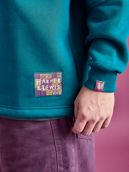Detail shot of the aztec branded badge and cuff tab on the sleeve, this are both in the same pattern.