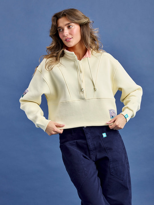 Additional features include contrast inside collar in Light Peach,  branded back neck tape in Navy, set-in sleeves, and ribbed cuffs and open hem