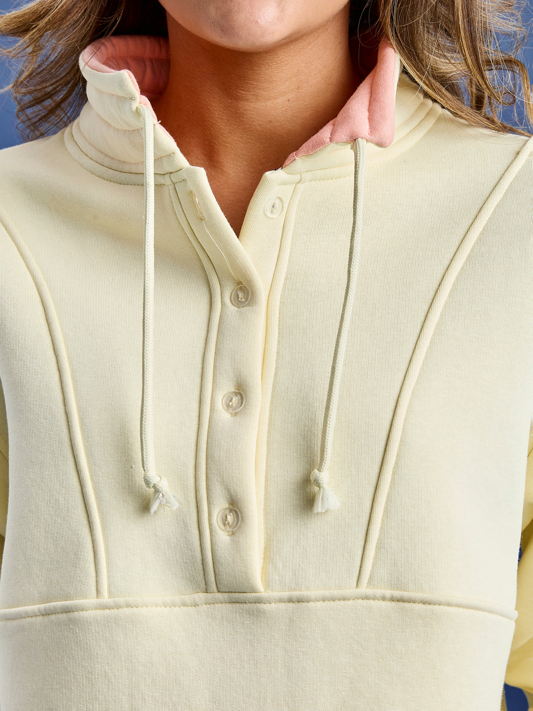 The Dahlia cropped sweater features a button feature inside of our classic zip