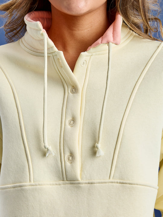 The Dahlia cropped sweater features a button feature inside of our classic zip