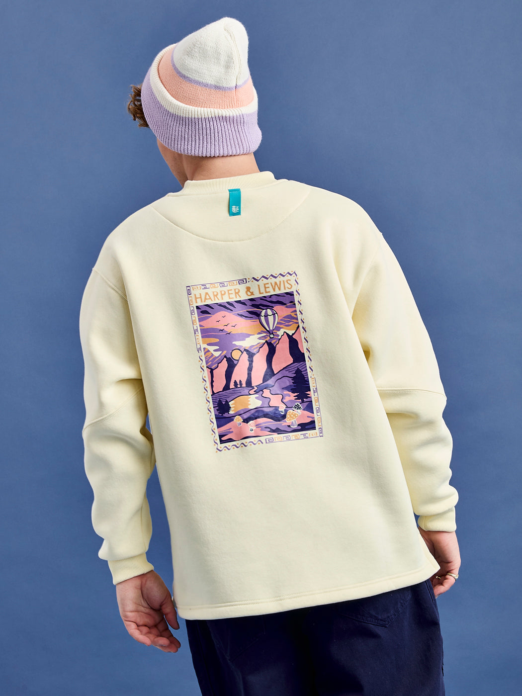 Detail shot of the back of the Atlas unisex sweater, which features a brand tab on the back neck.