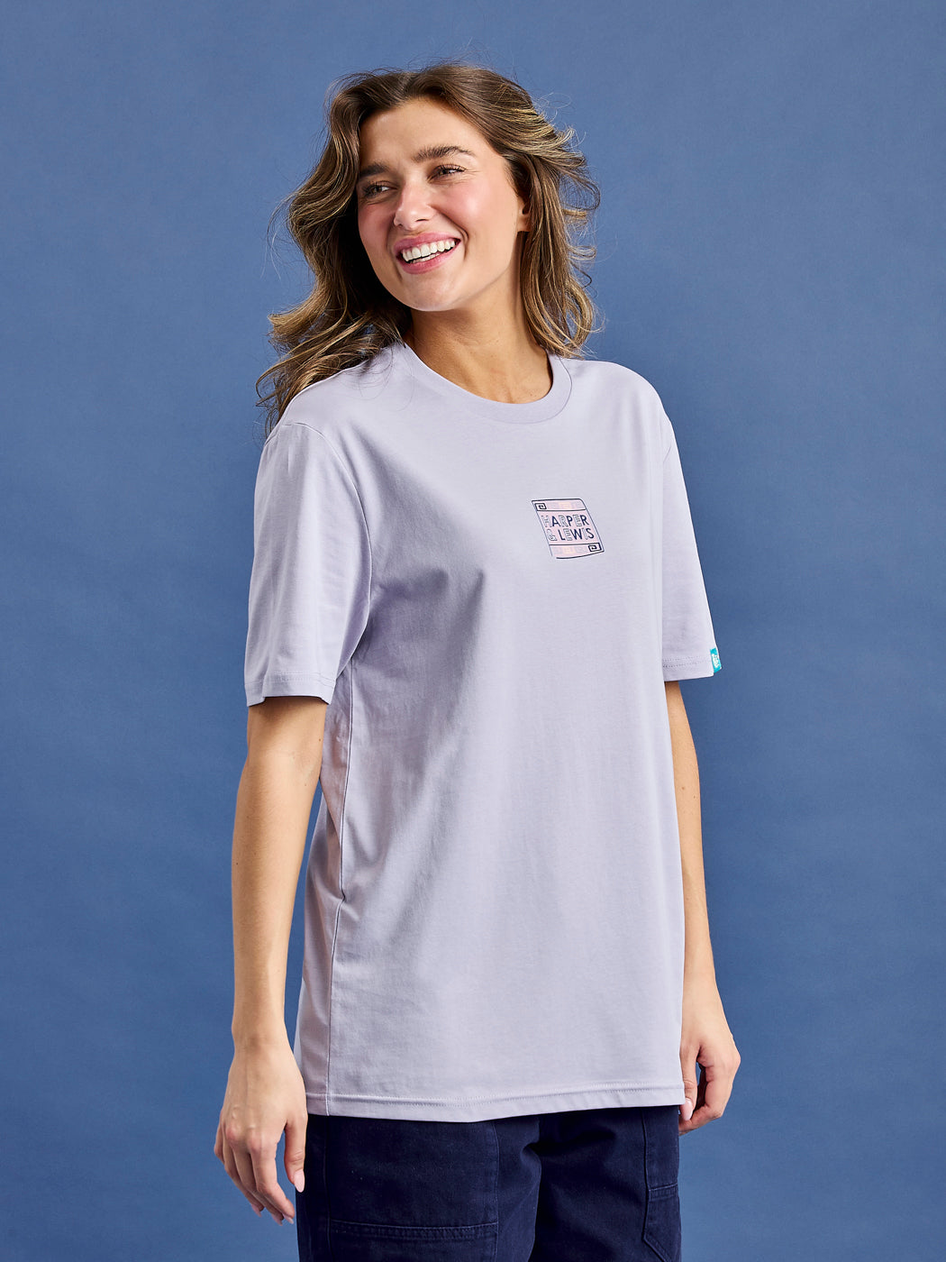 Female model wears the printed tee in an oversized fit