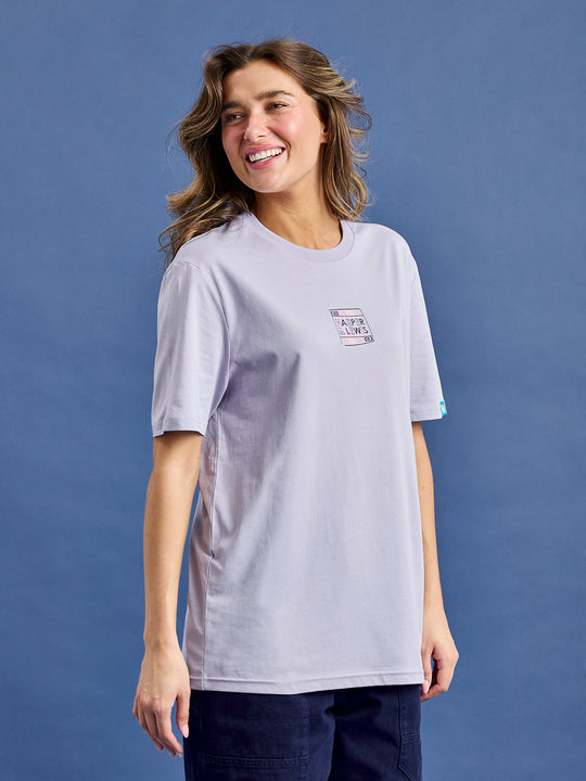 Female model wears the printed tee in an oversized fit