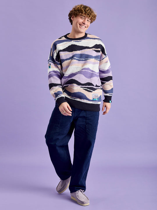 Male Model wearing the oversized sweat jumper featuring a vibrant pattern in shades of Light Peach, Pale Airforce, Deep.