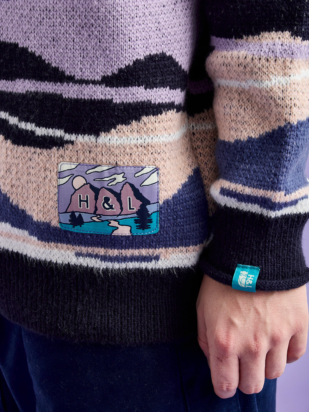 Detail shot of the Mountain inspired woven badge and tab on the cuff.