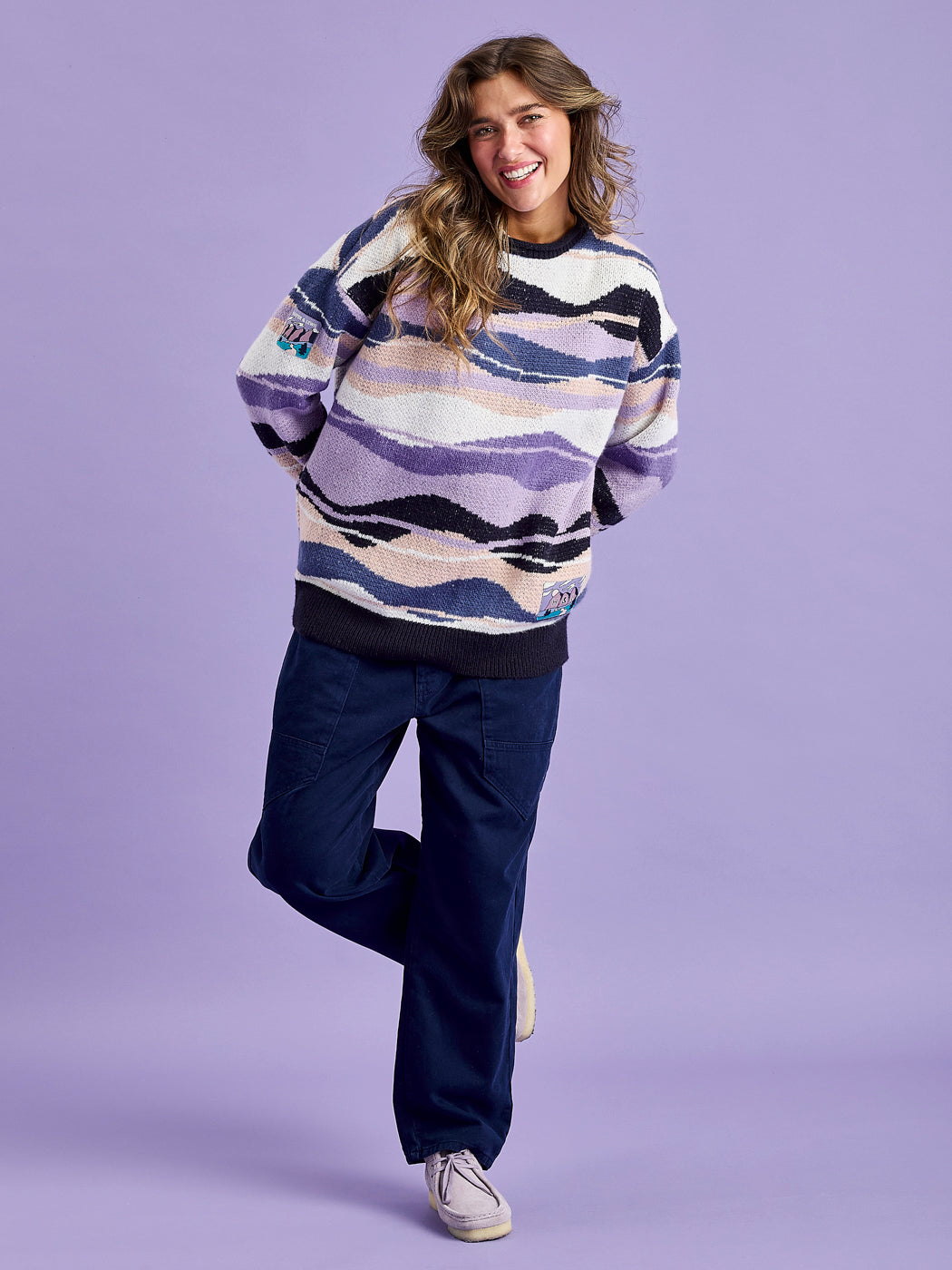 Female Modell wearing the oversized vintage inspired jumper, featuring badge details.