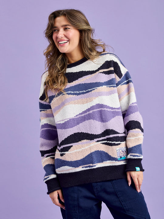 Female Model wearing the knitted unisex jumper with Contrast ribbed cuffs, neckline, and hem in Navy.