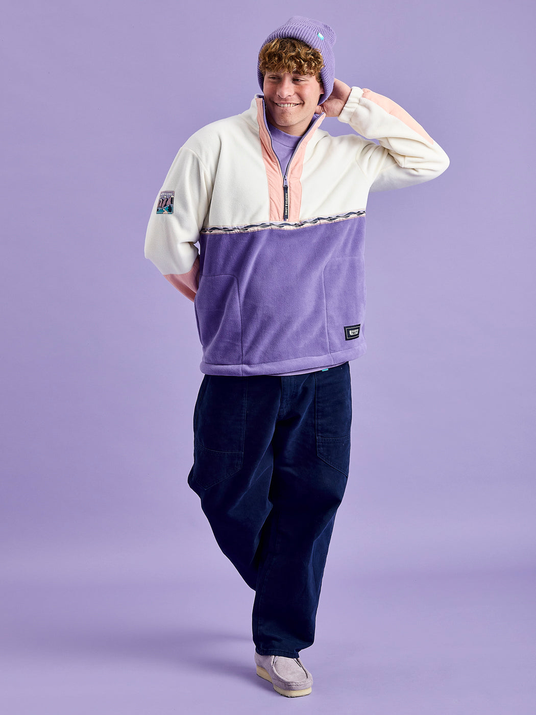 Male Model wears the Tory Fleece Jacket styled with the Asani Trousers in Navy.