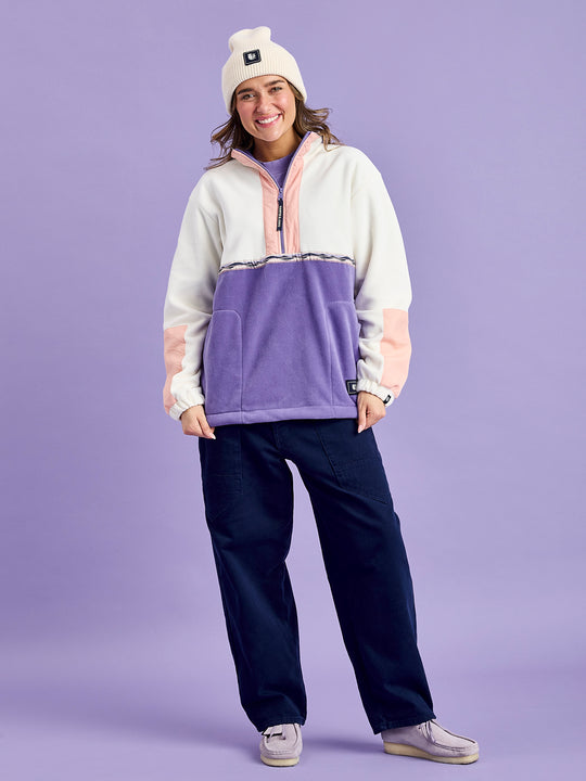 Female Model wears the Tory fleece jacket which has a colour block style with a Mountain Wave woven tape around the body.
