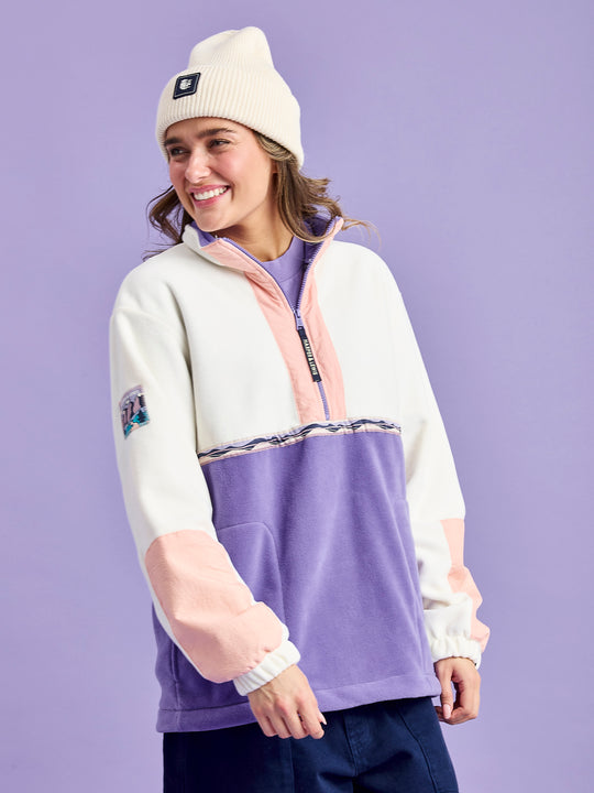 Female Model wears the Tory 1/2 zip fleece jacket with features a purple inside collar.