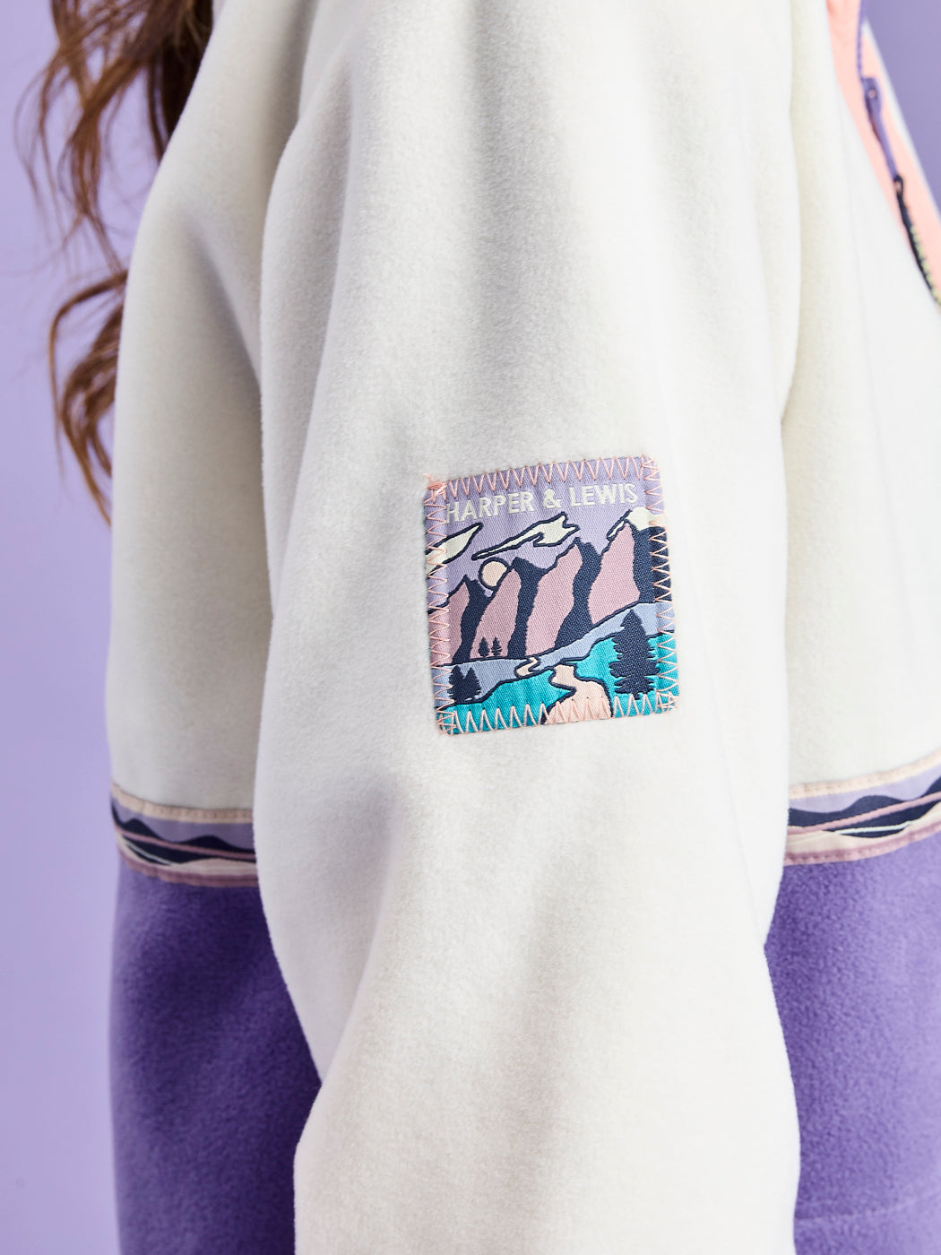 Detail shot of the Branded retro inspired mountain badge on the arm.