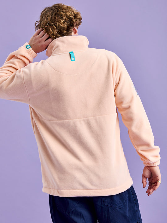 Teal badges on the cuff and the back of the neck of the fleece jacket.