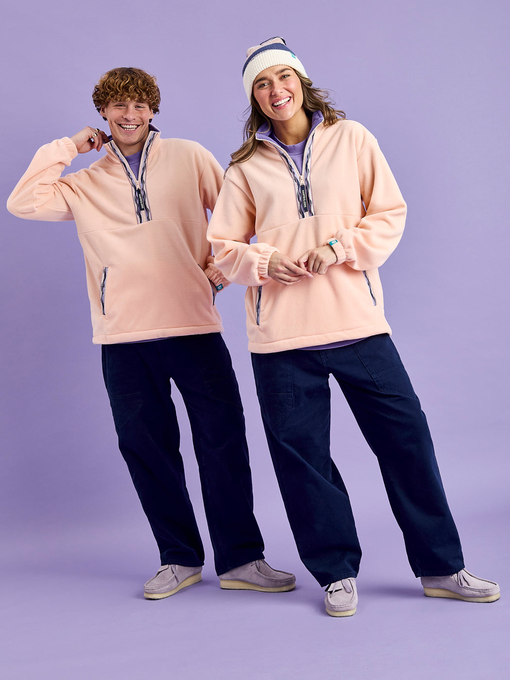 Two Models wearing the Unisex Fleece in Light Peach.