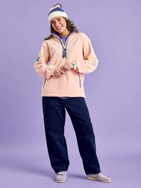 Female model wearing the light peach fleece jacket perfect for the autumn winter days.