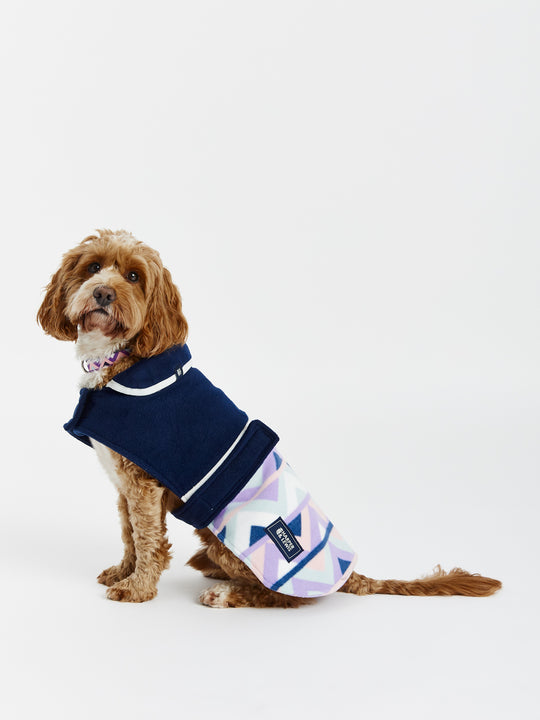 The branded badge at the collar adds a touch of style to this patterned dogs coat.