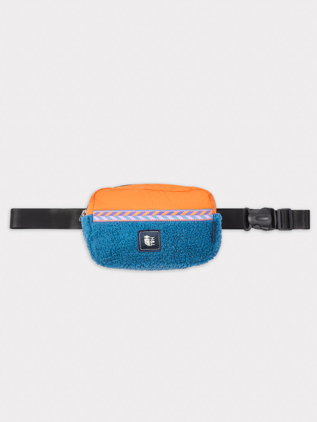 Made from plush sherpa fleece in striking Petrol and Apricot tones, this bumbag offers both comfort and a bold aesthetic.