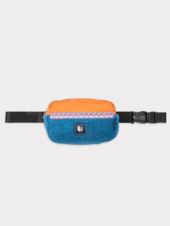 Made from plush sherpa fleece in striking Petrol and Apricot tones, this bumbag offers both comfort and a bold aesthetic.