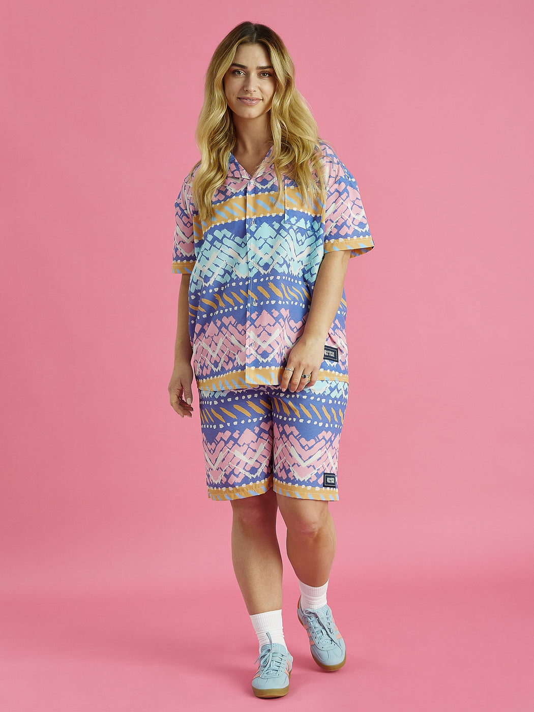 Female model wears the Cove shorts with matching shirt, the shorts feature a elasticated waistband with a drawcord, ensuring a perfect fit.