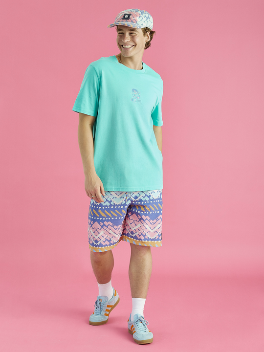 Male model showing the mint aura tee. This has a relaxed fit and has a front and back graphic