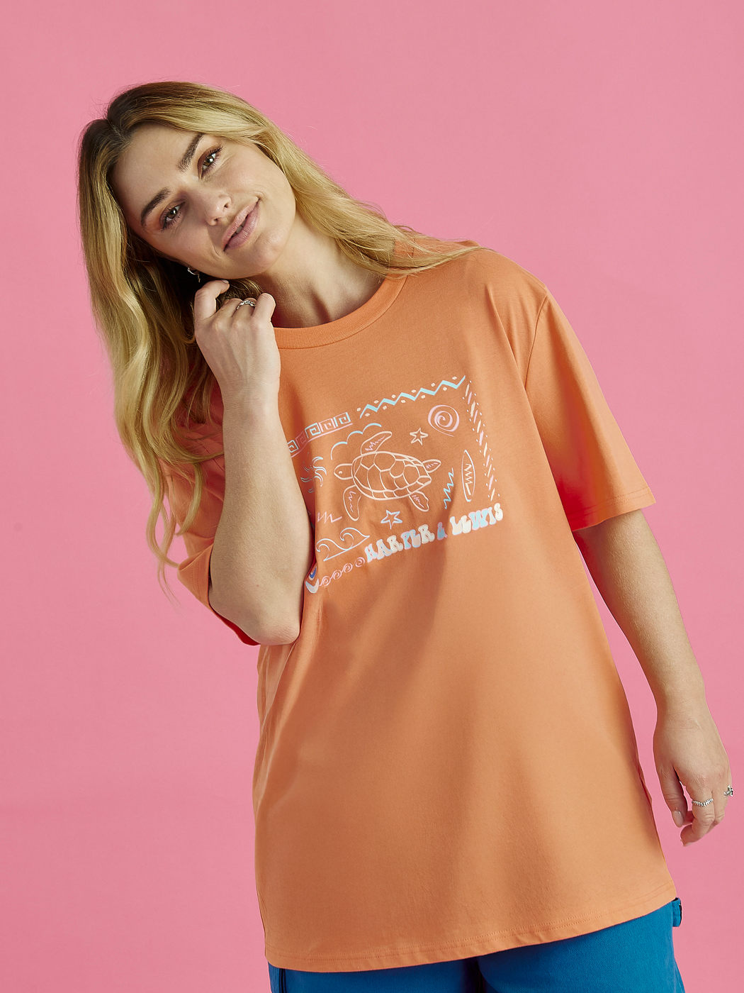 Female Model wearing the Surya t-shirt in Apricot, this tshirt has a relaxed fit.