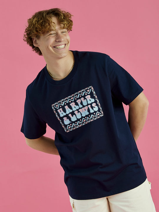 Male Model wearing the Taran tee in navy blue, this tee features a big front chest logo design.